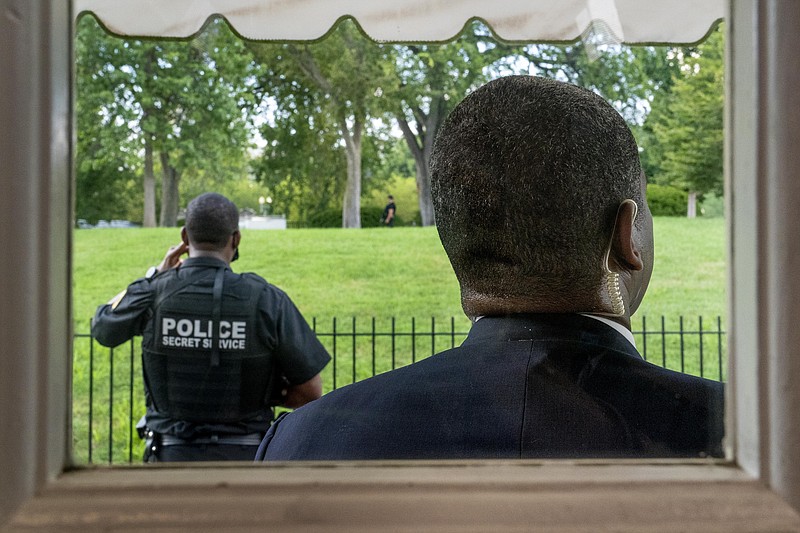 Members of the U.S. Secret Service stand guard outside the James Brady Press Briefing Room as President Donald Trump holds a news conference at the White House, Monday, Aug. 10, 2020, in Washington. Trump briefly left because of a security incident outside the fence of the White House. (AP Photo/Andrew Harnik)
