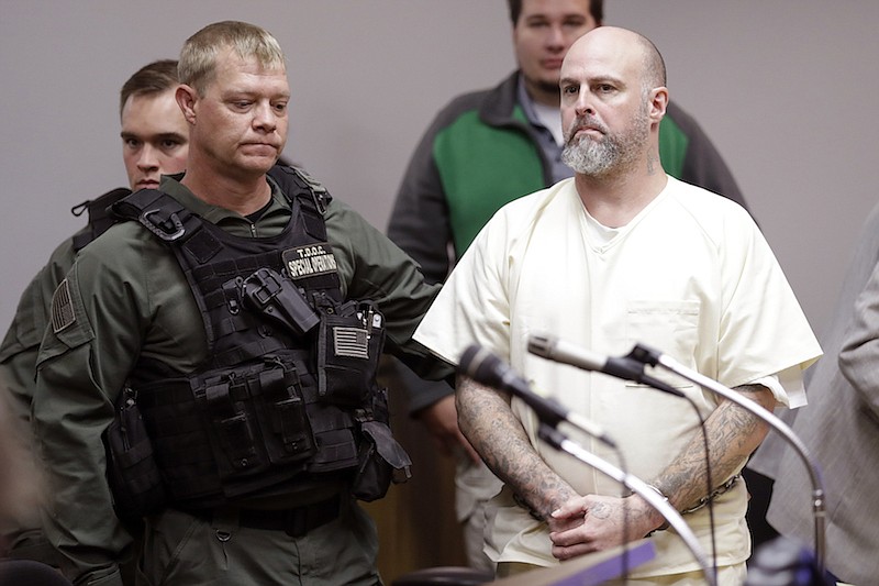 Curtis Watson, right, stands as a preliminary hearing is recessed in this Wednesday, Nov. 20, 2019 file photo, in Ripley, Tenn. Shernaye Johnson filed a lawsuit in federal court Friday, Aug. 7, 2020 suing the facility and its warden, seeking a jury trial and $5 million in damages for the death of her mother, Debra Johnson. Curtis Ray Watson has been charged with raping and killing Johnson and escaping the prison on a tractor. (AP Photo/Mark Humphrey, Pool, File)