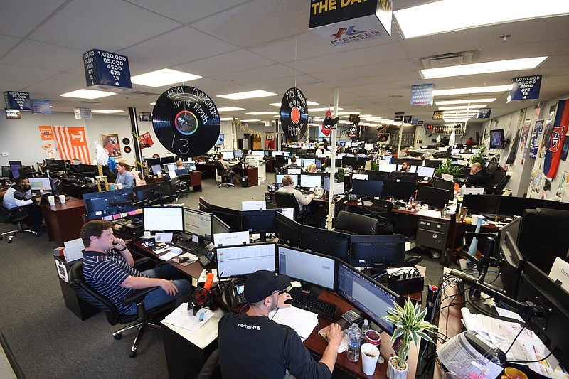 Staff file photo / Freight brokers show their achievements with record albums above their desks at Avenger Logistics.