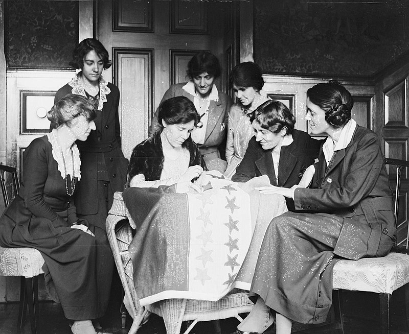 In this 1920 photo, women in Washington, D.C., sew stars on a suffrage flag as states ratify the 19th Amendment granting them the right to vote. Tennessee would be the 36th, and last, star on the flag as that number was what was needed to pass the amendment. / Photo from the Library of Congress