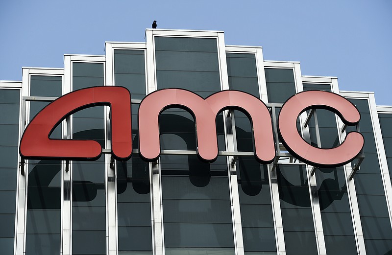 In this April 29, 2020 file photo, the AMC sign appears at AMC Burbank 16 movie theater complex in Burbank, Calif. AMC Theaters, the nation's largest chain, is pushing back its plans to begin reopening theaters by two weeks. The company said Monday that it would open approximately 450 U.S. locations on July 30 and the remaining 150 the following week. (AP Photo/Chris Pizzello, File)