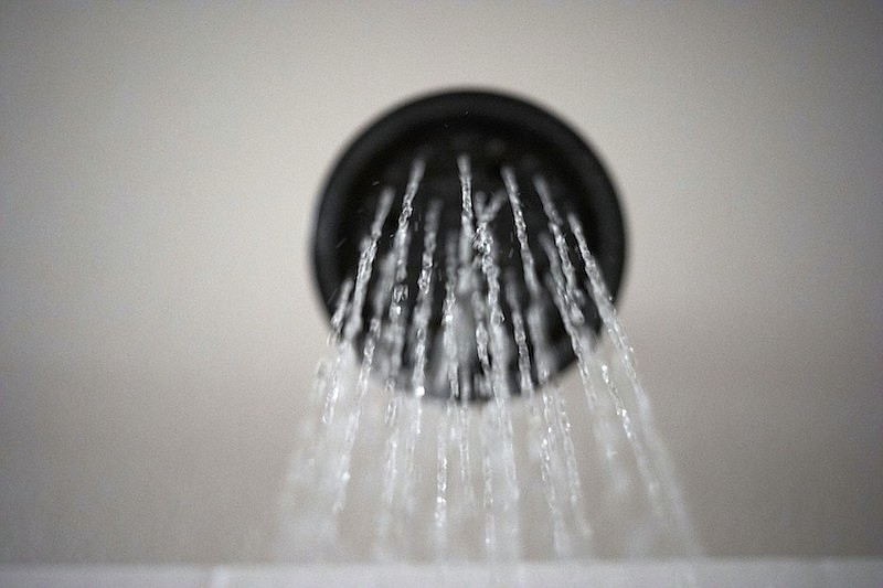 Water flows from a showerhead on Wednesday, Aug. 12, 2020, in Portland, Ore. The Trump Administration wants to change the definition of a showerhead to let more water flow. But consumer and conservation groups said the Department of Energy's proposed loosening of a 28-year-old energy law is silly, unnecessary and wasteful, especially as the West bakes through a historic two-decade-long megadrought. (AP Photo/Jenny Kane)