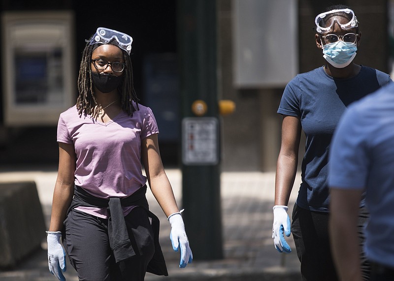 Staff photo by Troy Stolt / Tiara and Tia Ball wear masks as they cross Market Street on Friday, Aug. 7, 2020 in Chattanooga, Tenn.