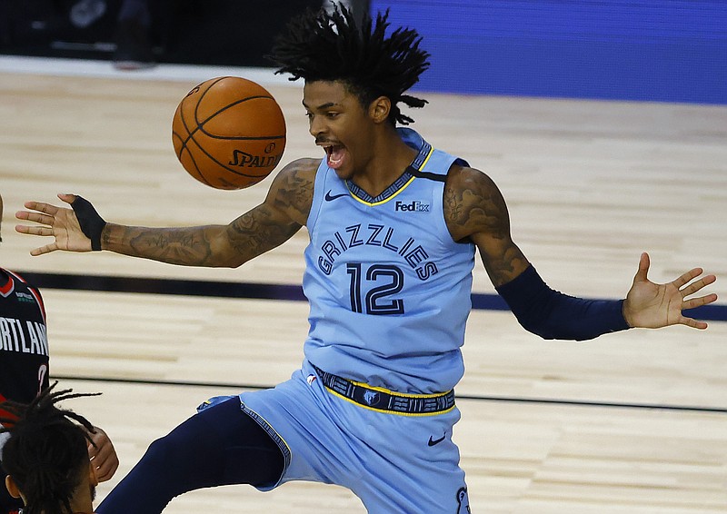 AP photo by Kevin C. Cox / Memphis Grizzlies rookie Ja Morant comes down after dunking against the Portland Trail Blazers on Saturday in Lake Buena Vista, Fla.