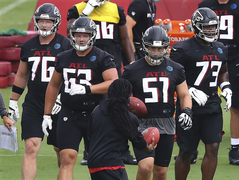 AP photo by Curtis Compton / From left, Atlanta Falcons offensive linemen Kaleb McGary, Chris Lindstrom, Alex Mack and Matt Gono practice Saturday during training camp in Flowery Branch, Ga.