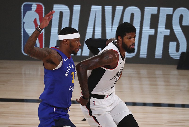 AP photo by Kim Klement / Los Angeles Clippers guard Paul George, right, tries to get past Denver Nuggets forward Torrey Craig on Wednesday in Lake Buena Vista, Fla.