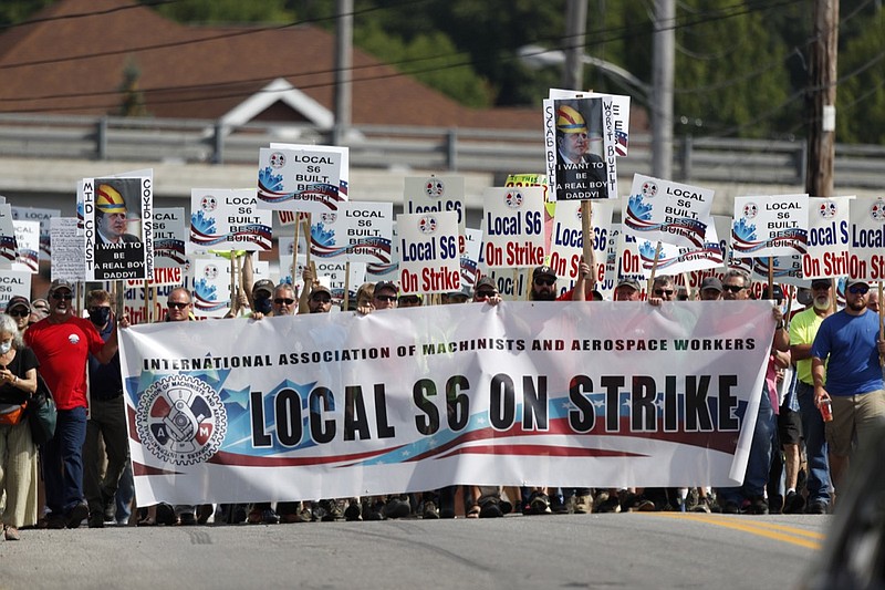 FILE - In this July 25, 2020, file photo, striking Bath Iron Works shipbuilders march in solidarity, Saturday, in Bath, Maine. The production workers went on strike June 22 after overwhelmingly rejecting the company's final contract proposal. The dispute centers on subcontractors, work rules and seniority. (AP Photo/Robert F. Bukaty, File)