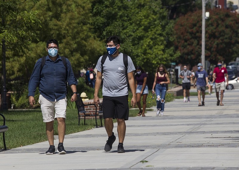 Staff photo by Troy Stolt / Senior engineering majors Eduardo Baez and Erik Loredo walk toward the University Center on campus at UTC on Monday, Aug. 17, 2020 in Chattanooga, Tenn. Monday was UTC's first day of in person classes since March, when all University of Tennessee schools moved to virtual classes in an effort to stop the spread of COVID-19.