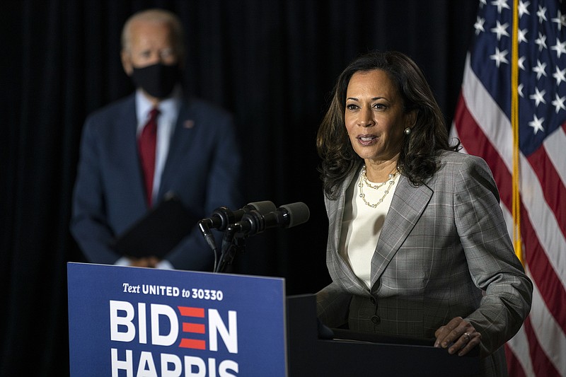 Photo by Carolyn Kaster of The Associated Press / Democratic presidential candidate former Vice President Joe Biden stands at left as his running mate, Sen. Kamala Harris, D-California, speaks at the Hotel DuPont in Wilmington, Delware, on Thursday, Aug. 13, 2020.