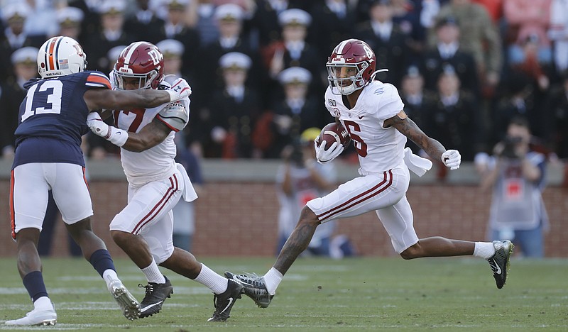 Crimson Tide photos / Alabama receiver DeVonta Smith looks for running room during last year's Iron Bowl at Auburn. The Crimson Tide and Tigers will play again this year on Thanksgiving week, which is the next to last week of this year's season.