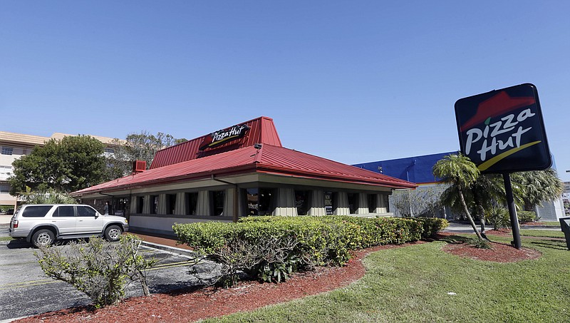A Pizza Hut in Miami is shown in 2017. Pizza Hut has reached an agreement with one of its largest franchisees to close 300 underperforming U.S. restaurants.