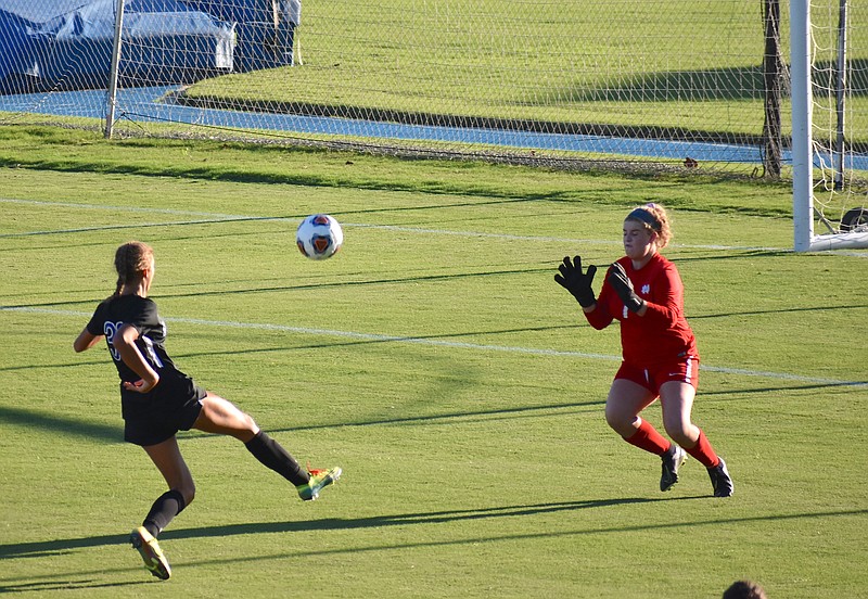 Staff photo by Patrick MacCoon / GPS sophomore Kennedy Ball chips in a high-arching goal over Notre Dame keeper Gracen Brewster in the first half of Monday's season opener at GPS.