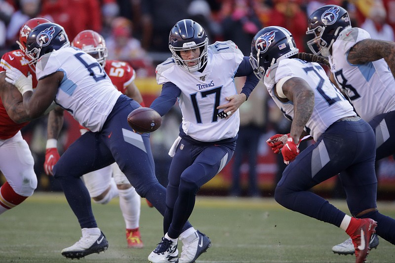 AP photo by Charlie Riedel / Tennessee Titans quarterback Ryan Tannehill (17) hands off to Derrick Henry during the 2020 AFC championship game against the host Kansas City Chiefs.