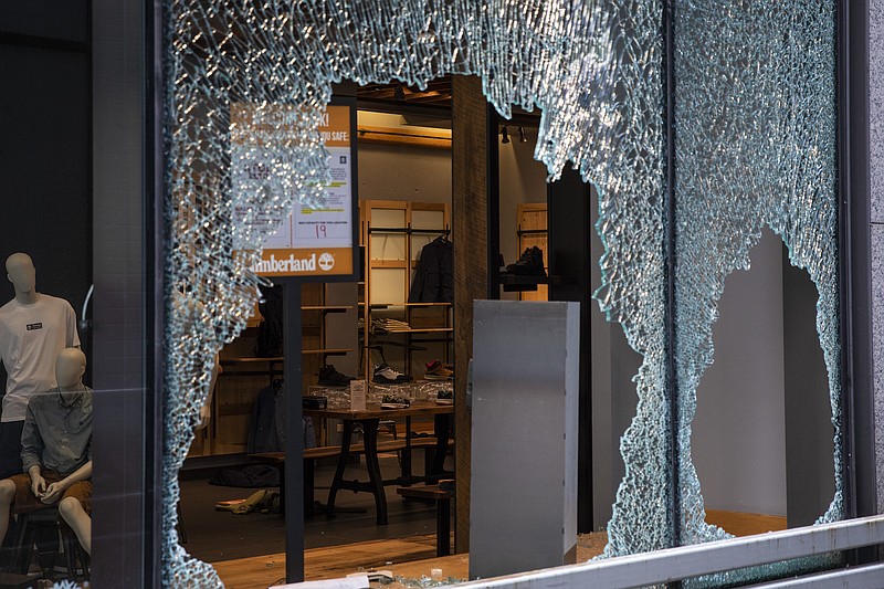 Photo by Ashlee Rezin Garcia of the Chicago Sun-Times via The Associated Press / The Timberland store is damaged after looting broke out overnight in the Loop and surrounding neighborhoods on Monday morning, Aug. 10, 2020, in Chicago.