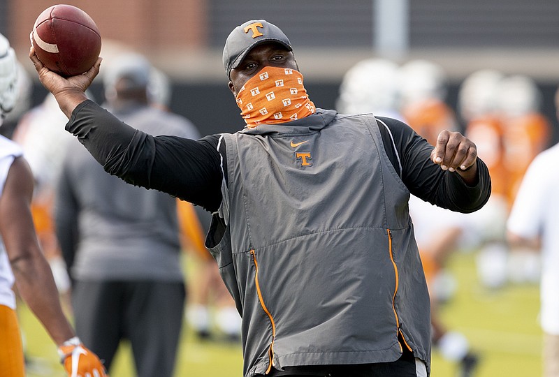 Tennessee Athletics photo by Andrew Ferguson / Tennessee receivers coach and passing game coordinator Tee Martin, the quarterback who guided the Volunteers to the 1998 national championship, throws a pass during Monday's opening day of preseason practice at Haslam Field.