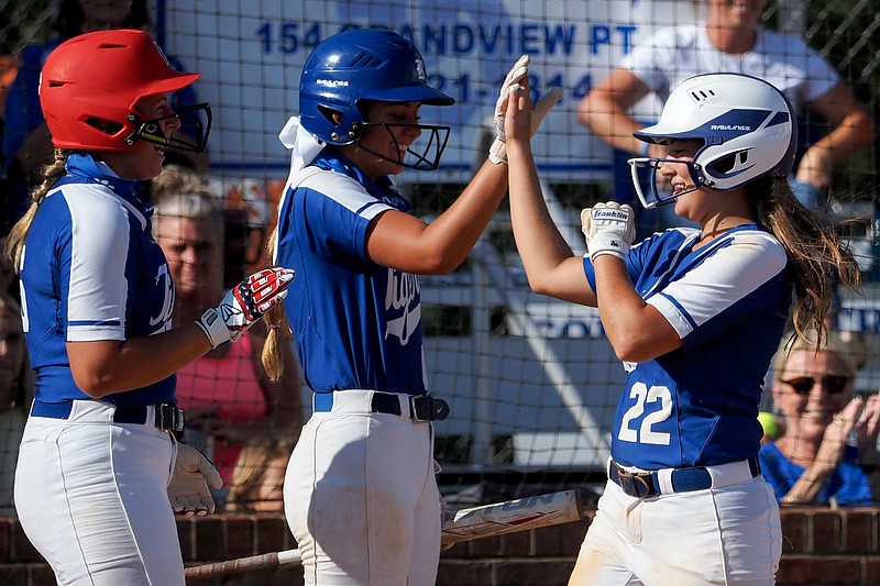 Staff photo by C.B. Schmelter / Ringgold's Caroline Hemphill (22) greets softball teammates Addi Broome, center, and Ava Raby at home plate after hitting a two-run homer against Coahulla Creek at Hazel Brown Field on Tuesday in Ringgold, Ga.