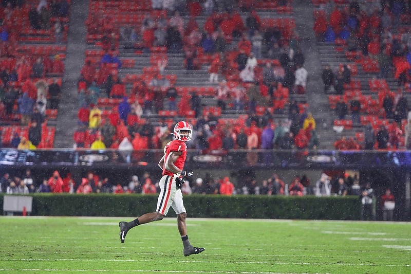 Georgia photo by Chamberlain Smith / Georgia receiver George Pickens heads to the sideline during last season's game against Kentucky in a driving rain. A scattering of fans will be the norm this season as social distancing is practiced during SEC games.