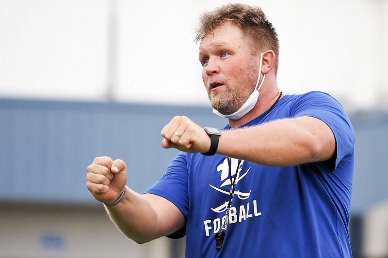 Staff photo by C.B. Schmelter / Boyd Buchanan football coach Jeremy Bosken works with the Buccaneers' offensive linemen during practice on Aug. 3 at David L. Boyd Field.