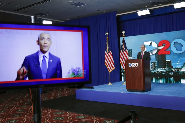 A screen plays a video of former president Barack Obama as Chairman of the Democratic National Committee Tom Perez waits to speak during day four of the virtual Democratic National Convention in Milwaukee, Wisconsin, on August 20, 2020. (Photo by KAMIL KRZACZYNSKI / AFP)
