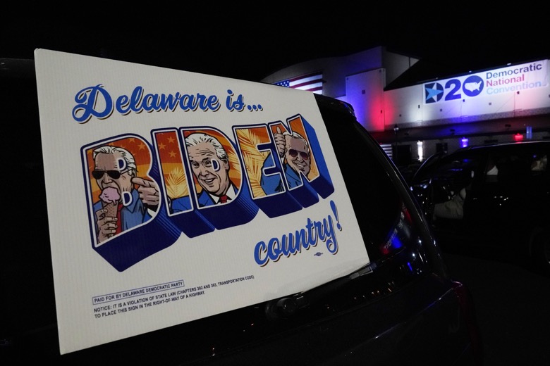 Supporters watch the program outside the venue where Democratic presidential candidate former Vice President Joe Biden will speak later tonight, during the final day of the Democratic National Convention, Thursday, Aug. 20, 2020, at the Chase Center in Wilmington, Del. (AP Photo/Carolyn Kaster)