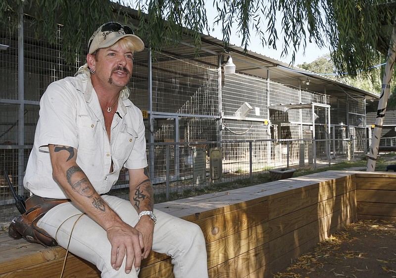 FILE - In this Aug. 28, 2013, file photo, the late Joseph Maldonado-Passage, also known as Joe Exotic, answers a question during an interview at the zoo he runs in Wynnewood, Okla. The Oklahoma zoo, featured in Netflix's "Tiger King" documentary, has closed after federal authorities investigated it for alleged maltreatment of animals and suspended its license. The Greater Wynnewood Exotic Animal Park closed to the public after the U.S. Department of Agriculture on Monday, Aug. 17, 2020, suspended the exhibitor license for current-owner Jeff Lowe for 21 days.(AP Photo/Sue Ogrocki, File)