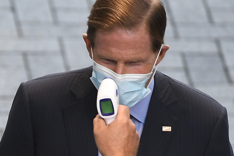 Sen. Richard Blumenthal, D-Conn., has his temperature checked before entering a watch party for the Democratic National Convention at Dunkin' Donuts Park, home of the Hartford Yard Goats minor league baseball team, Thursday, Aug. 20, 2020, in Hartford, Conn. (AP Photo/Jessica Hill)