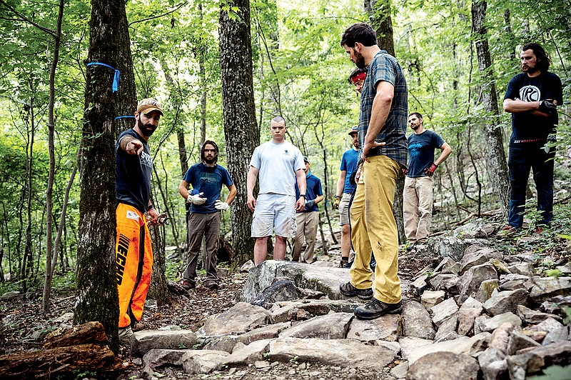 Contributed photo by Nathalie DuPre / A group of volunteers gather to discuss rock armoring during a trail-laying day.