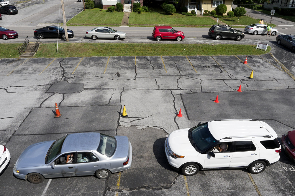 Staff photo by C.B. Schmelter / Cars wait in line to receive food from the Red Bank Community Food Pantry at Red Bank United Methodist Church on Thursday, Aug. 20, 2020 in Chattanooga, Tenn.