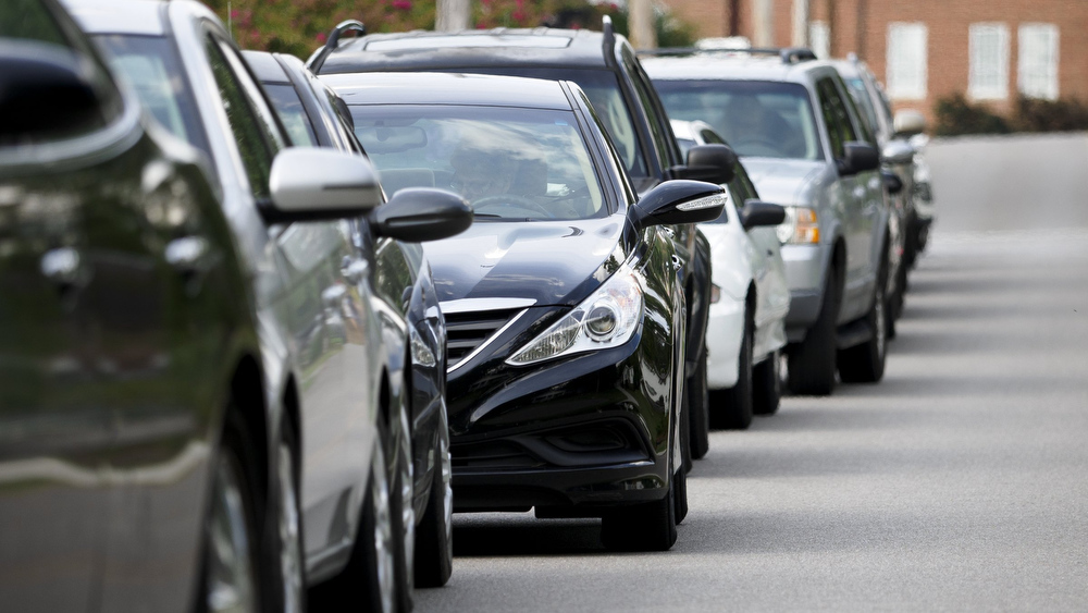 Staff photo by C.B. Schmelter / Cars wait in line to receive food from the Red Bank Community Food Pantry at Red Bank United Methodist Church on Thursday, Aug. 20, 2020 in Chattanooga, Tenn.