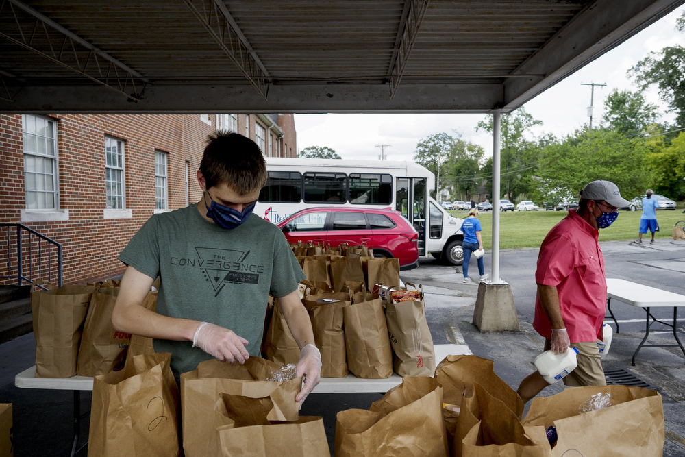 Staff photo by C.B. Schmelter / Deacon Murphy, left, and Devere Keller help distribute food at Red Bank United Methodist Church on Thursday, Aug. 20, 2020 in Chattanooga, Tenn.