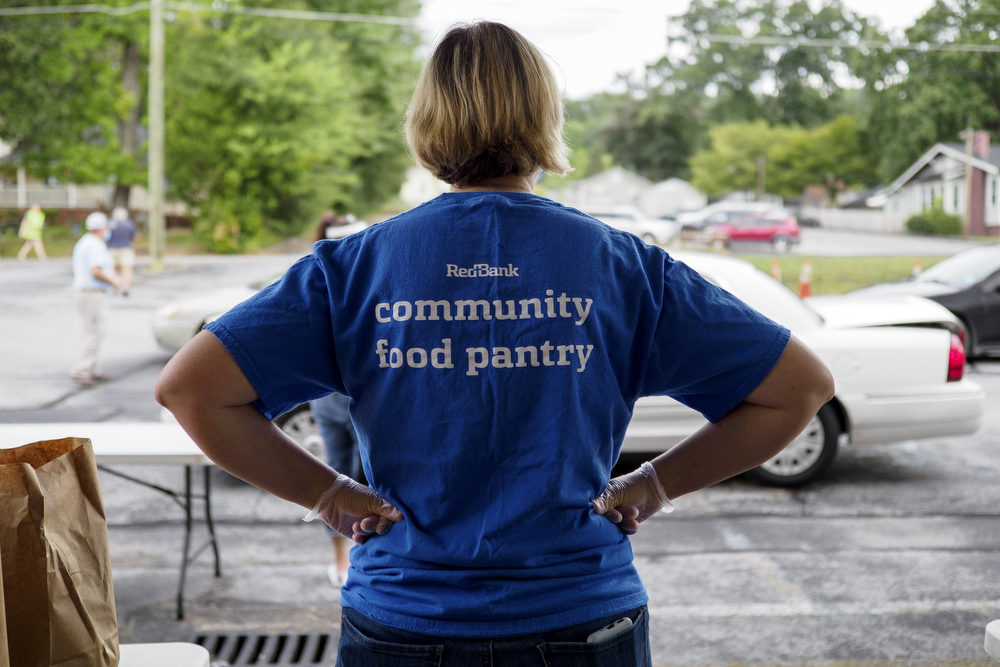 Staff photo by C.B. Schmelter / Nicky Murphy helps distribute food at Red Bank United Methodist Church on Thursday, Aug. 20, 2020 in Chattanooga, Tenn.