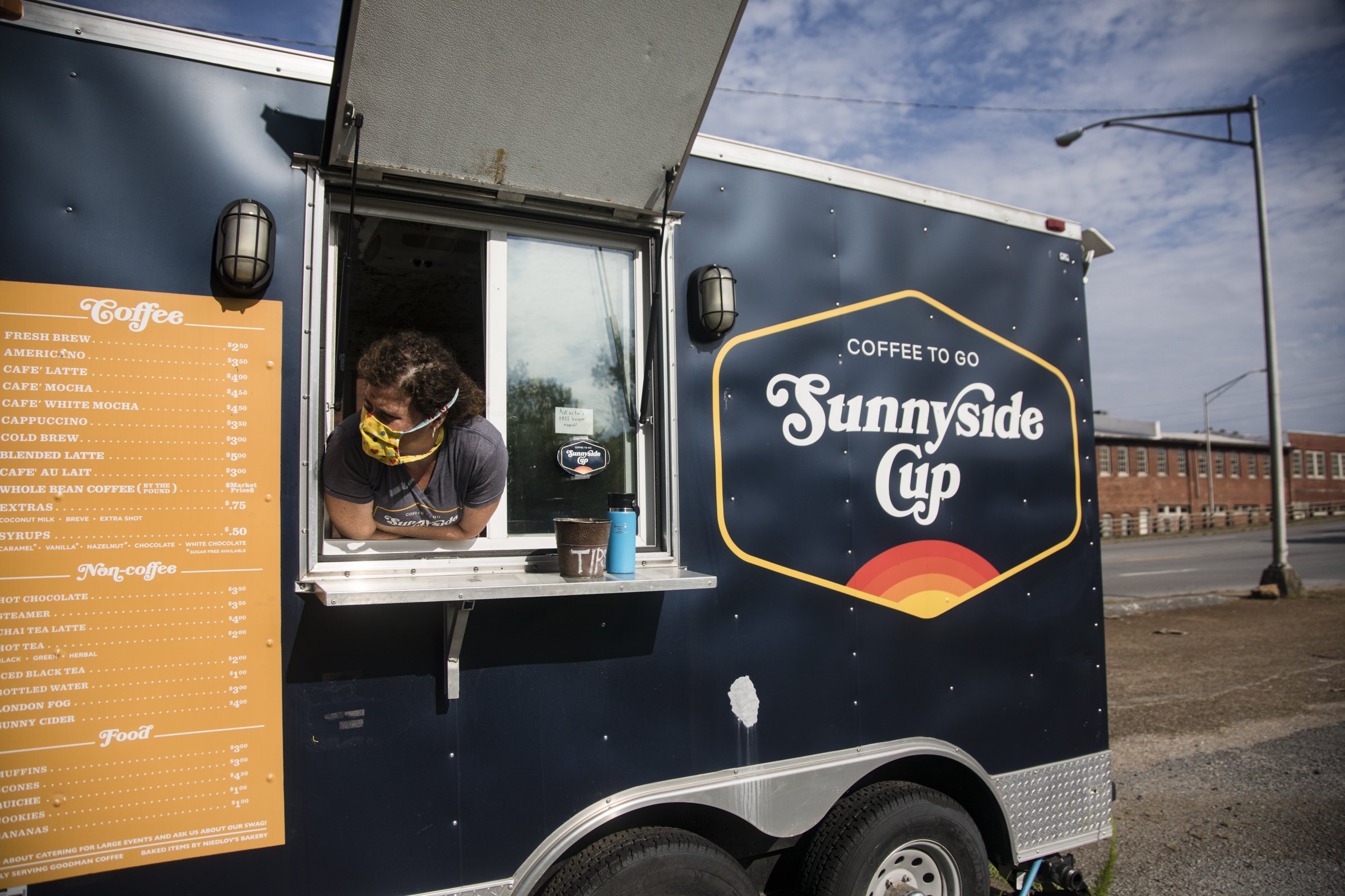 Staff photo by Troy Stolt / Melody Kobernick, owner of Sunnyside Cup peeks out of the window of the 3008 South Broad St. location. The to-go coffee shop recently announced it will be opening a new location on Signal Mountain Road.