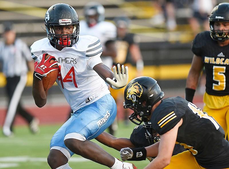 Staff photo by Robin Rudd / Brainerd's Donivon Thomas fends off two Hixson defenders to score a touchdown after making a catch during Friday's game at Hixson, the season opener for both teams.