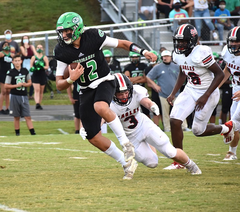 Staff photo by Patrick MacCoon / East Hamilton senior quarterback Haynes Eller makes a big play with his legs in the first quarter of Friday night's season-opening 34-7 home win over Signal Mountain.