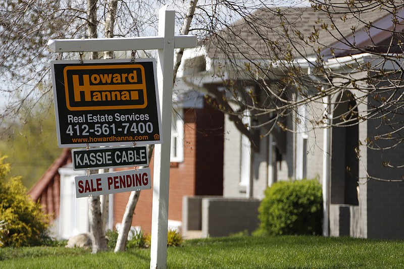 This Monday, April 27, 2020, file photo shows a sale pending sign on a home in Mount Lebanon, Pa. The coronavirus pandemic helped shape the housing market by influencing everything from the direction of mortgage rates to the inventory of homes on the market to the types of homes in demand and the desired locations. (AP Photo/Gene J. Puskar, File)