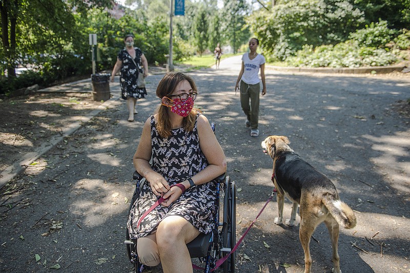 Kim McCoy, at New York's Central Park with her dog, Indie, on Aug. 10, 2020, wants to run ultramarathons again. McCoy, a nurse and ultrarunner, lost part of her leg after being hit by a car during a race. (Brittainy Newman/The New York Times)