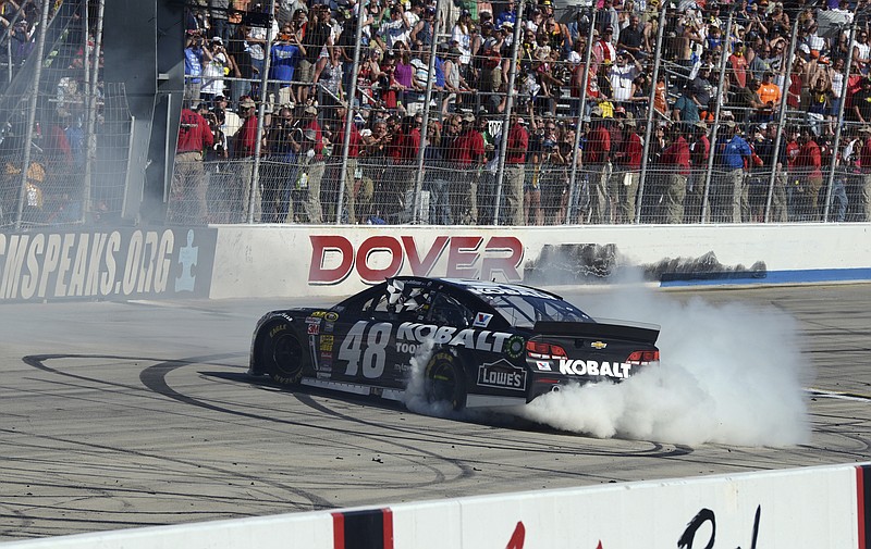 AP photo by Molly Riley / Jimmie Johnson does a celebratory burnout after winning a NASCAR Cup Series race at Delaware's Dover International Speedway on June 1, 2014. Johnson, who shares the record for season championships at seven with Dale Earnhardt and Richard Petty, also has a record with 11 Cup Series wins at Dover.