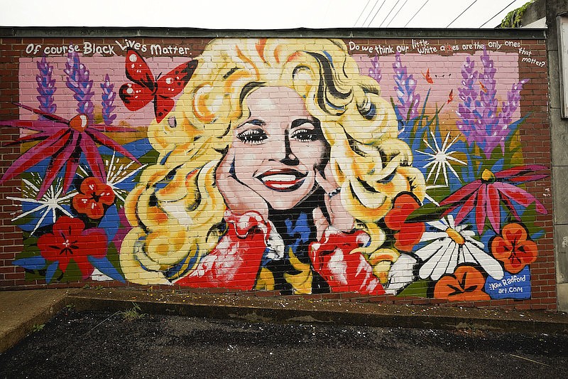 A mural of Dolly Parton is seen outside The 5 Spot, a music club in Nashville, Tenn., Friday, Aug. 21, 2020. Artist Kim Radford said Dolly fans from around the world have contacted her about the mural, which contains a quote from Parton about her support for the Black Lives Matter movement. (AP Photo/Mark Humphrey)