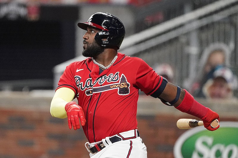 AP photo by John Bazemore / The Atlanta Braves' Marcell Ozuna follows through on a solo homer in the third inning of Friday night's home game against the Philadelphia Phillies.