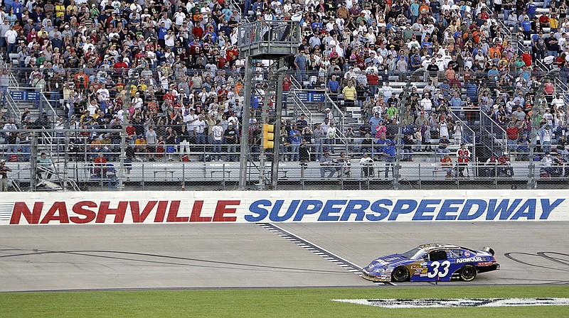 AP photo by Mark Humphrey / Kevin Harvick takes the checkered flag at the finish line to win the Nashville 300, a NASCAR Nationwide Series race on April 3, 2010, at Nashville Superspeedway in Gladeville, Tenn. NASCAR is set to return in 2021 to the speedway, which now has the first Black track president in the history of the stock car racing giant.