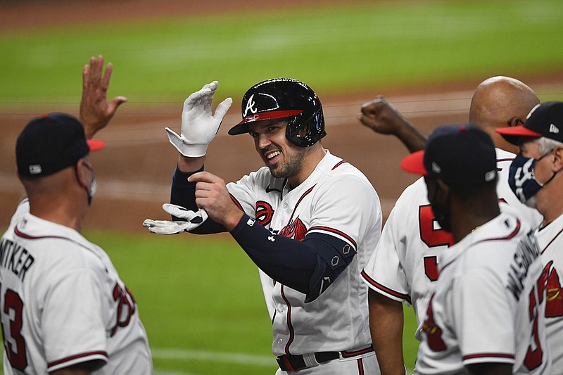 AP photo by John Amis /Adam Duvall, center, celebrates with his Atlanta teammates as he comes off the field after driving in the winning run with two outs in the bottom of the ninth of Saturday night's game against the Philadelphia Phillies, lifting the Braves to a 6-5 comeback win.