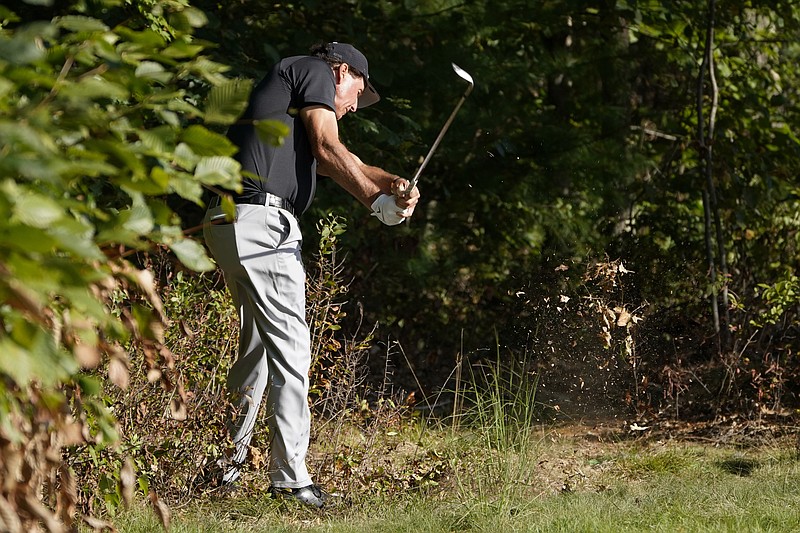 AP photo by Charles Krupa / Phil Mickelson hits out of the woods attempting to reach the 14th green at TPC Boston during the second round of The Northern Trust on Friday in Norton, Mass.