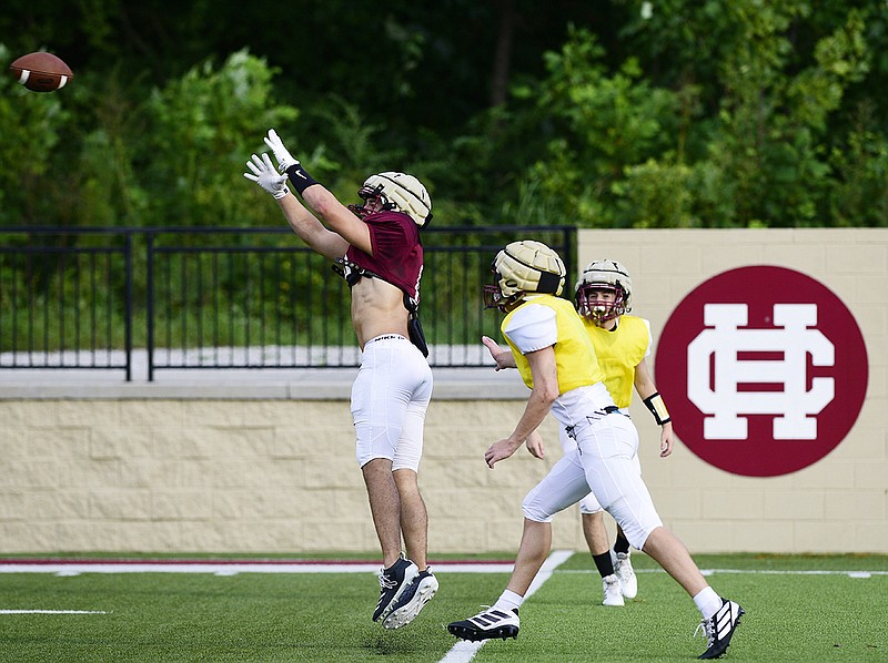 Staff photo by Robin Rudd / Christian Heritage's Evan Lester, left, leaps to make a catch during the Lions' football practice on Aug. 13 in Dalton, Ga. Northwest Georgia programs Christian Heritage, Gordon Lee and Trion are among those affected by the latest round of GHSA reclassification that created a true public-private split in Class A.