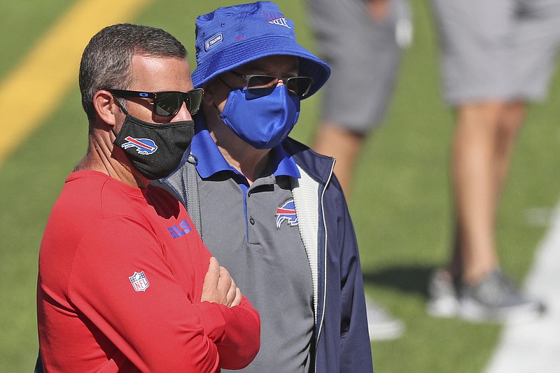 AP photo by James P. McCoy / Buffalo Bills general manager Brandon Beane, left, and team owner Terry Pegula watch practice at training camp on Thursday in Orchard Park, N.Y.