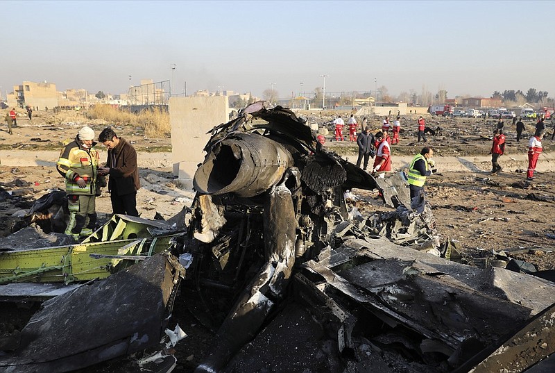 FILE - In this Jan. 8, 2020, file photo, debris at the scene where a Ukrainian plane crashed in Shahedshahr southwest of the capital Tehran, Iran. Iran has retrieved some data, including a portion of cockpit conversations, from the Ukrainian jetliner accidentally downed by the Revolutionary Guard forces in January, killing all 176 people on board, an Iranian official said Sunday, Aug. 23, 2020. (AP Photo/Ebrahim Noroozi, File)