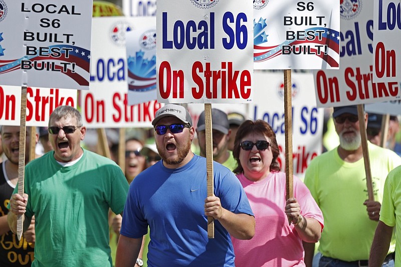 FILE - In this July 25, 2020 file photo, striking Bath Iron Works shipbuilders march in solidarity in Bath, Maine. A 63-day strike at Bath Iron Works — against the backdrop of a pandemic in an election year — came to an end Sunday, Aug. 23 with shipbuilders voting to return to their jobs producing warships for the United States Navy. (AP Photo/Robert F. Bukaty, File)