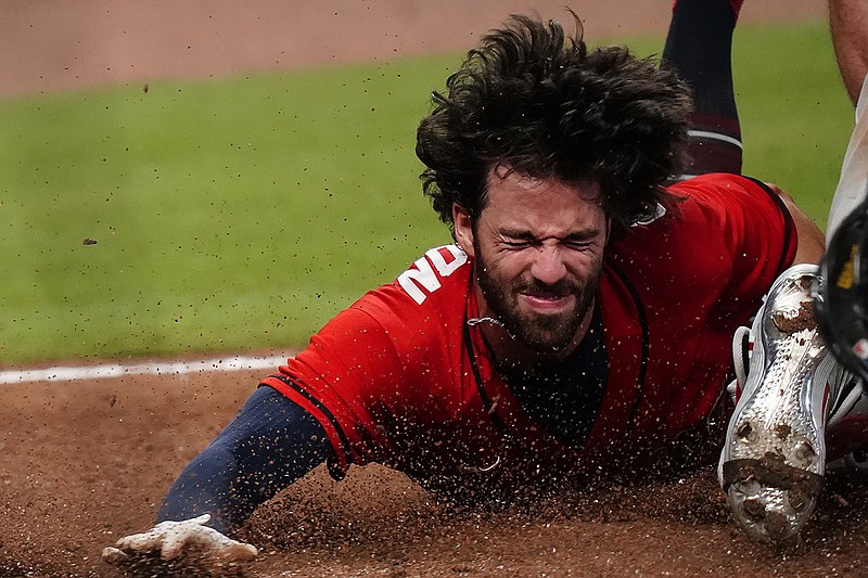 AP photo by Brynn Anderson / Atlanta's Dansby Swanson dives into home plate and is tagged out by Philadelphia Phillies catcher Andrew Knapp during the ninth inning of Sunday night's game at Truist Park. The host Braves lost 5-4.