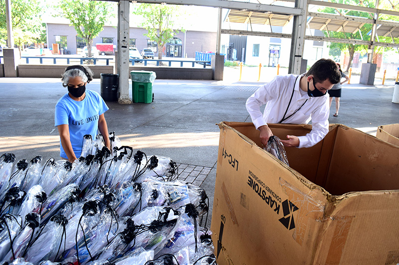 Staff Photo by Robin Rudd / Smita Donthamsetty, left, and Parker Allison unload backpacks.