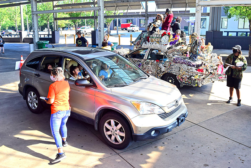 Staff Photo by Robin Rudd / A family exits the First Horizon Pavilion past a decorated "art car."