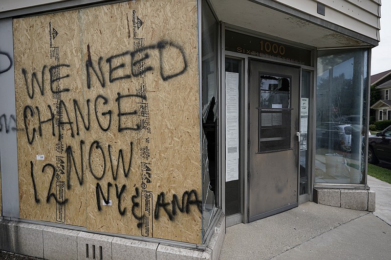 Photo by Morry Gash of the Associated Press / Damage is seen after earlier protests, Aug. 25, 2020, in Kenosha, Wisconsin. Anger over the shooting of Jacob Blake, a Black man, by police spilled into the streets of Kenosha for a second night Monday.